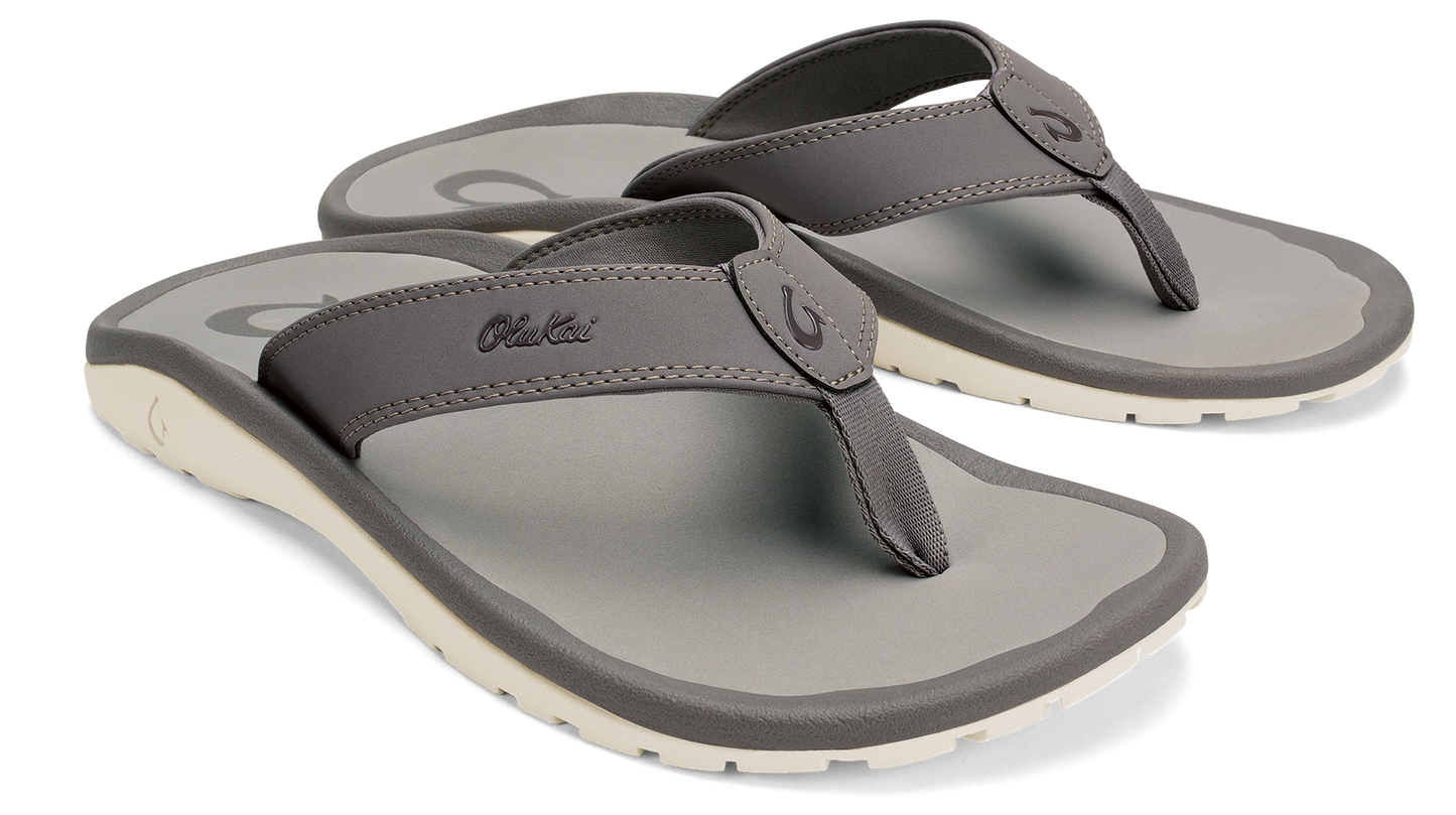 Pair of gray flip flops with off-white soles.