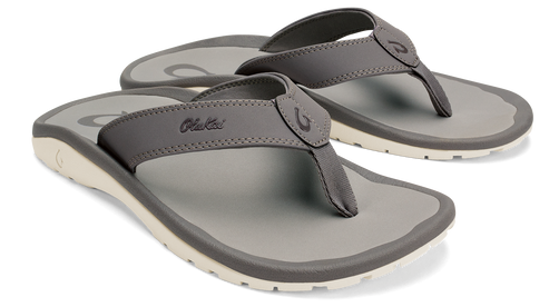 Pair of gray flip flops with off-white soles.