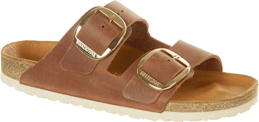 A pair of light brown, two-strap sandals with large gold buckles.