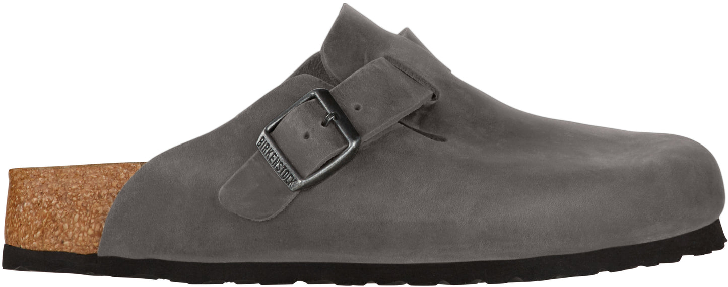 A gray clog with a buckle strap.