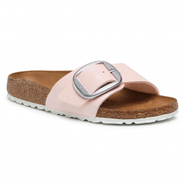 Pink slide sandal with large silver buckle, cork footbed and white sole.