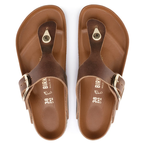 Pair of brown leather thong-style sandals with gold buckles. The insole has "BIRK" and shoe size embossed on it.