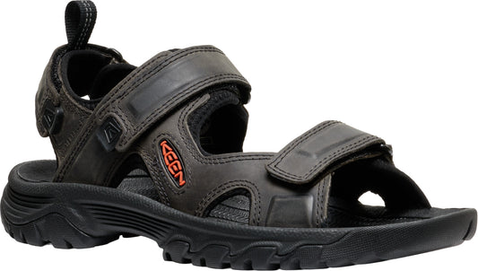 Black leather sandals with velcro straps, black sole, and an orange logo.
