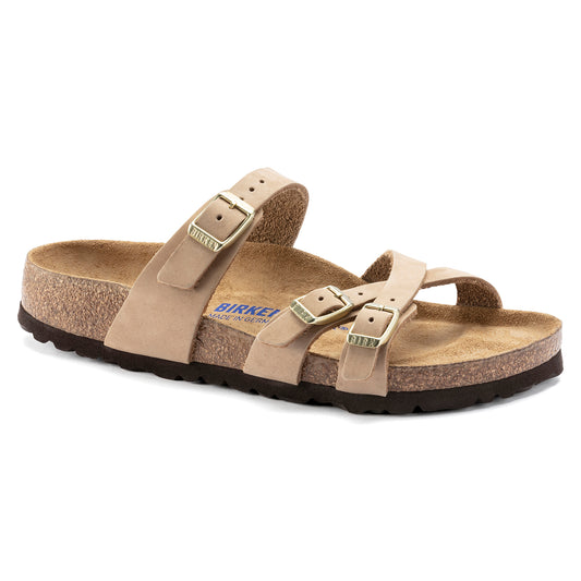 Tan slide sandal with 3 adjustable straps, visible text "BIRKENSTOCK MADE IN GERMANY", on a cork sole.