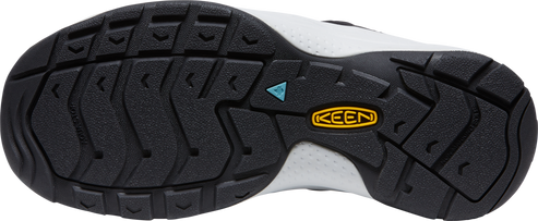 A shoe sole with a black tread pattern and a yellow logo that says KEEN.