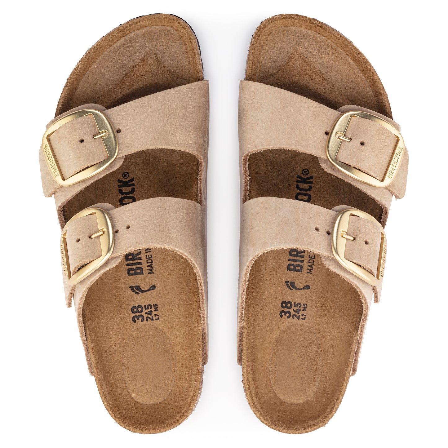 Pair of beige, two-strap sandals with large gold buckles.