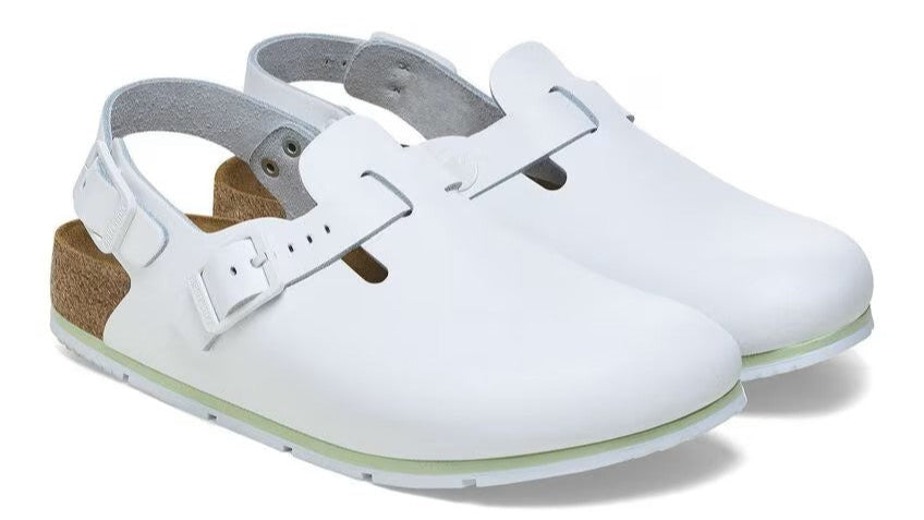 White clogs with adjustable heel strap and buckle closure, cork sole.