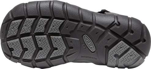 Bottom view of a black shoe with a thick, lugged sole featuring zig-zag patterns and a KEEN logo.