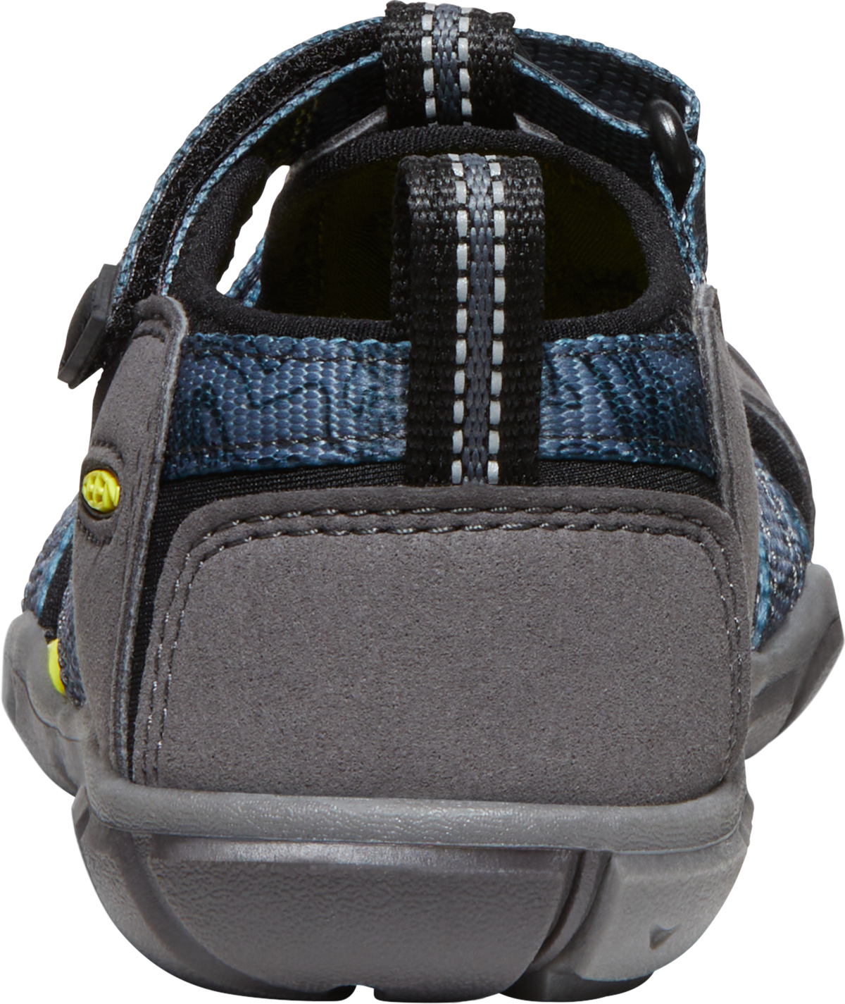 Back view of a shoe with blue textile material, gray suede accents, and a black hook-and-loop fastener strap.