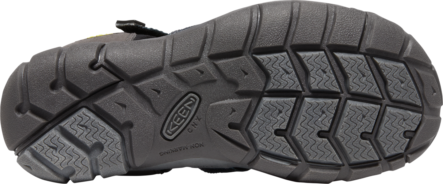 A black shoe sole with the brand 'KEEN' imprinted, showing textured patterns.