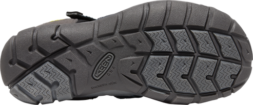 A black shoe sole with the brand 'KEEN' imprinted, showing textured patterns.
