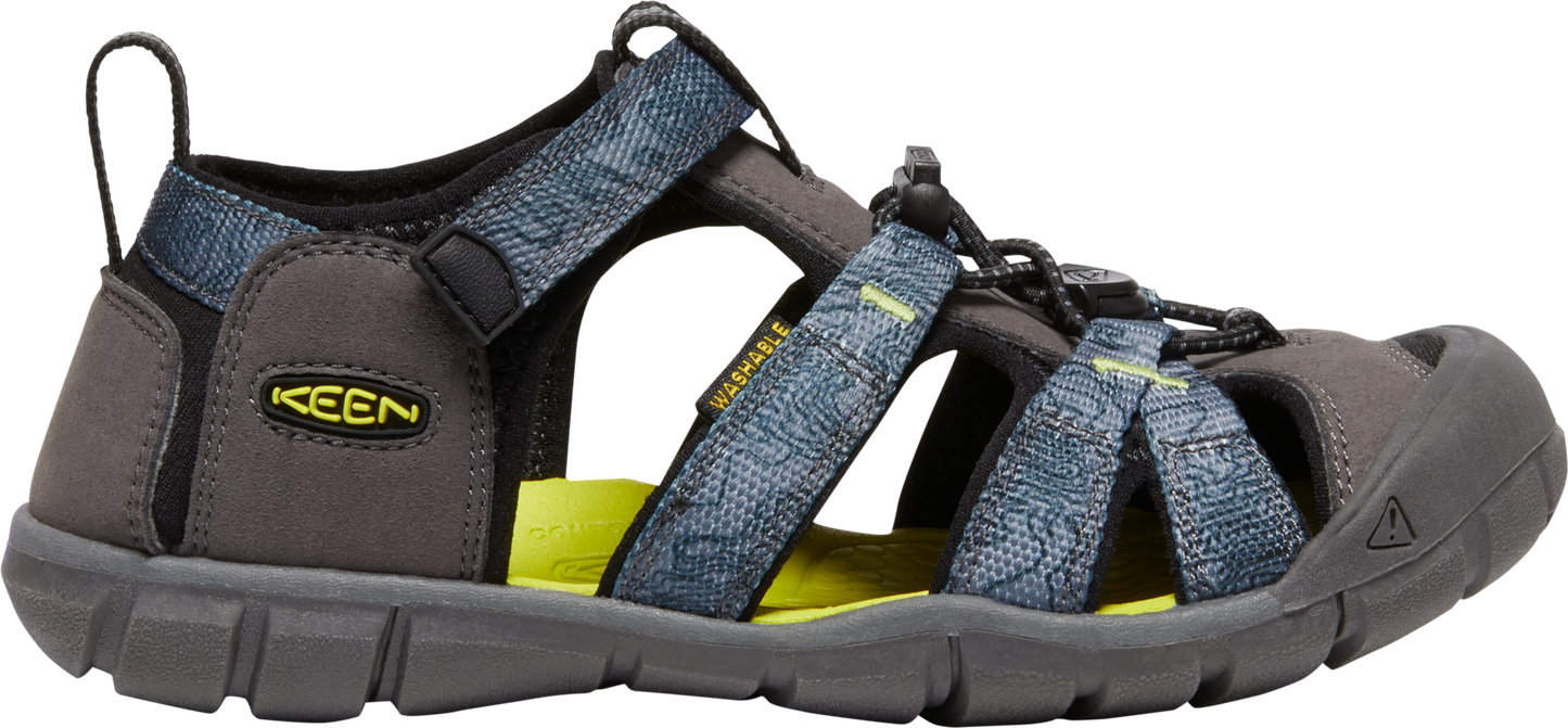 A gray sandal with blue patterned straps and a yellow insole.