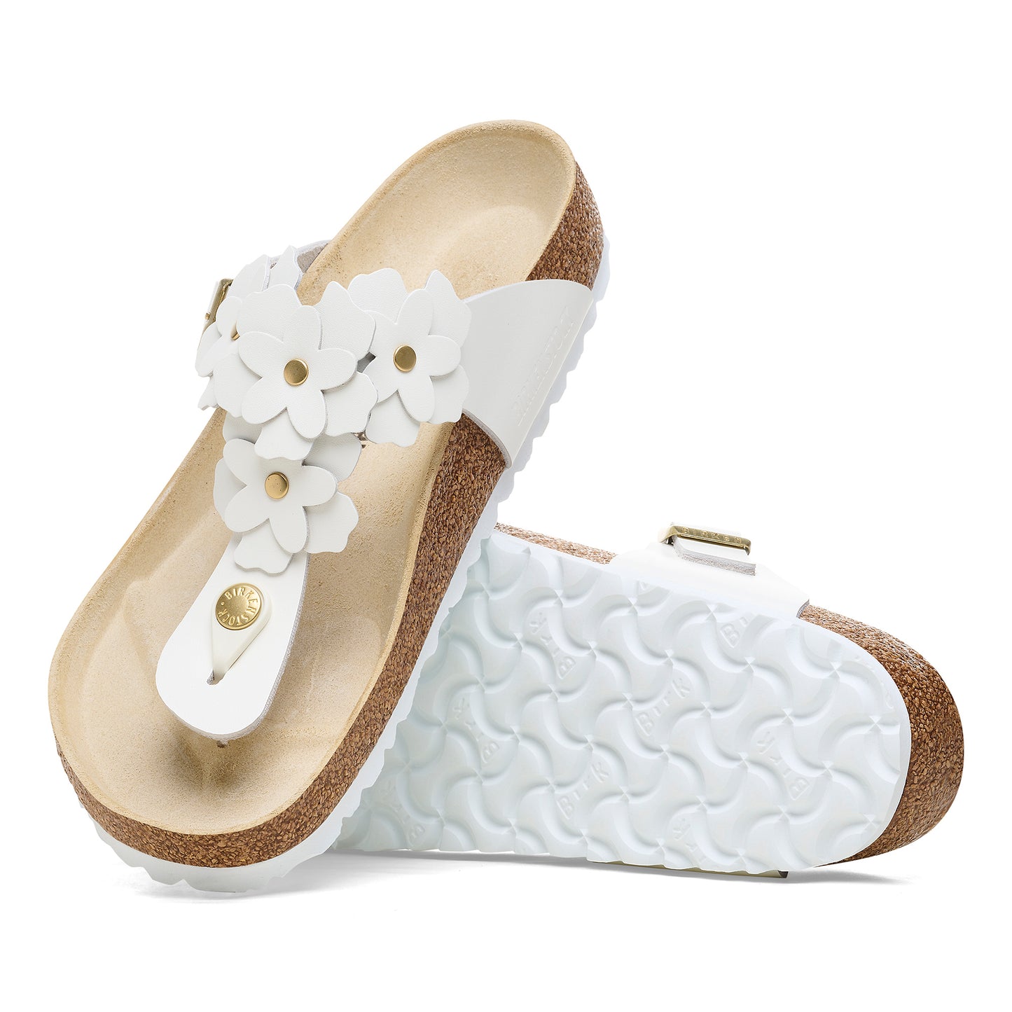 A pair of white sandals with floral decoration, showing the sole and insole.