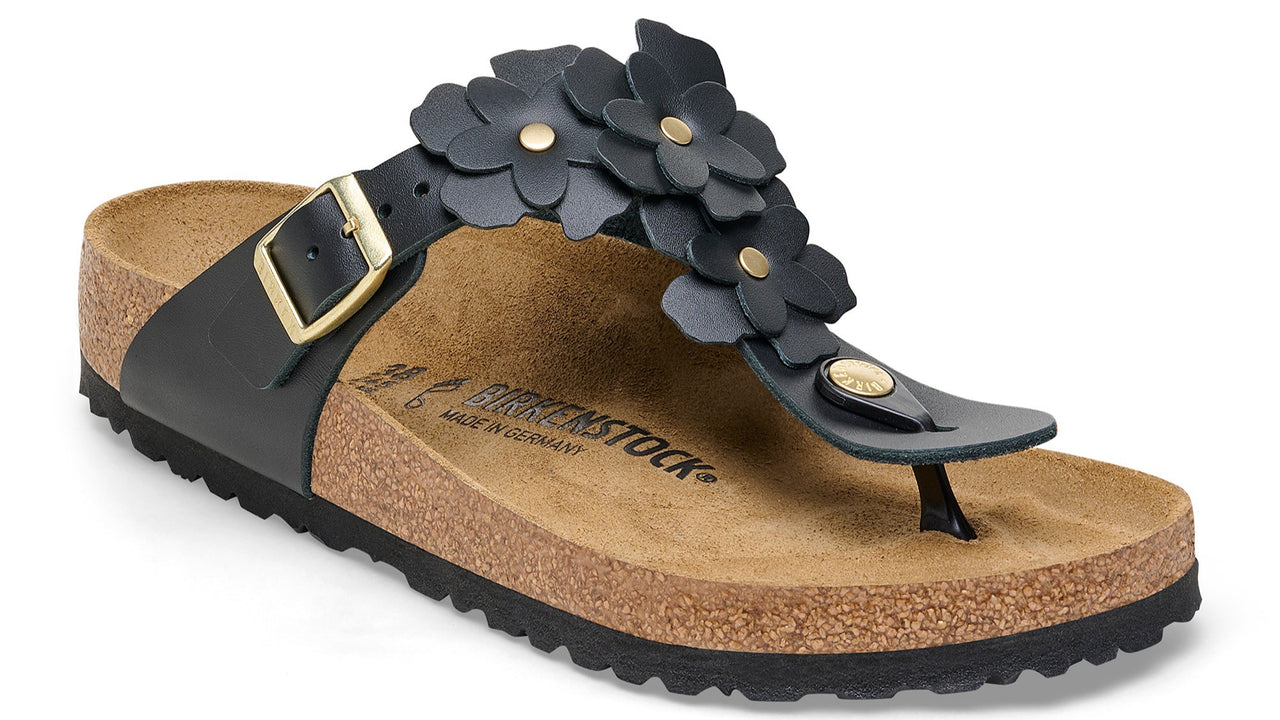Black sandal with cork sole and flower embellishments.