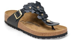 Black sandal with cork sole and flower embellishments.