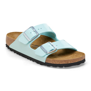 Light blue two-strap sandal with adjustable silver buckles and a cork sole.
