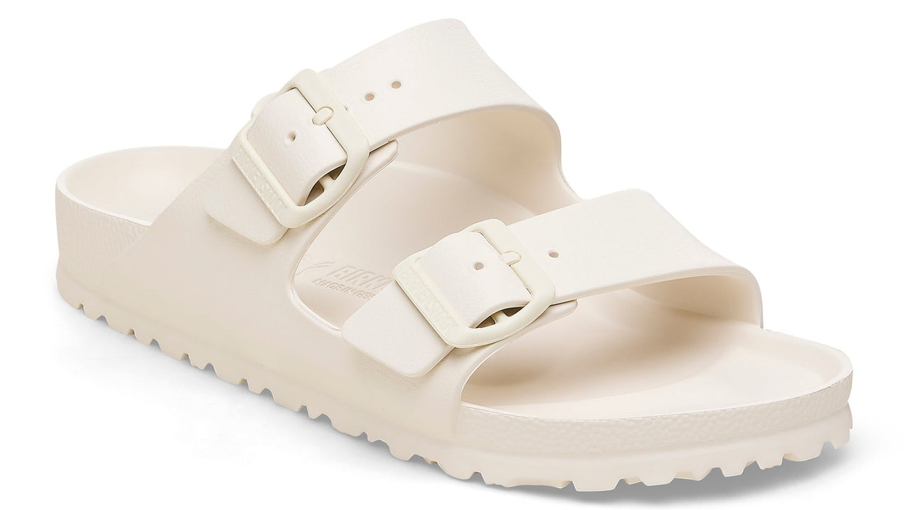 Off-white, two-strap adjustable slide sandal with buckle hardware.