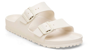 Off-white, two-strap adjustable slide sandal with buckle hardware.