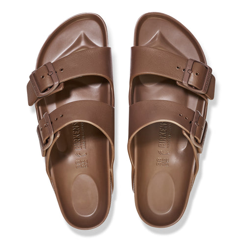 Top-down view of brown two-strap sandals with buckles.