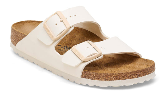 White two-strap sandal with adjustable buckles and a cork footbed.