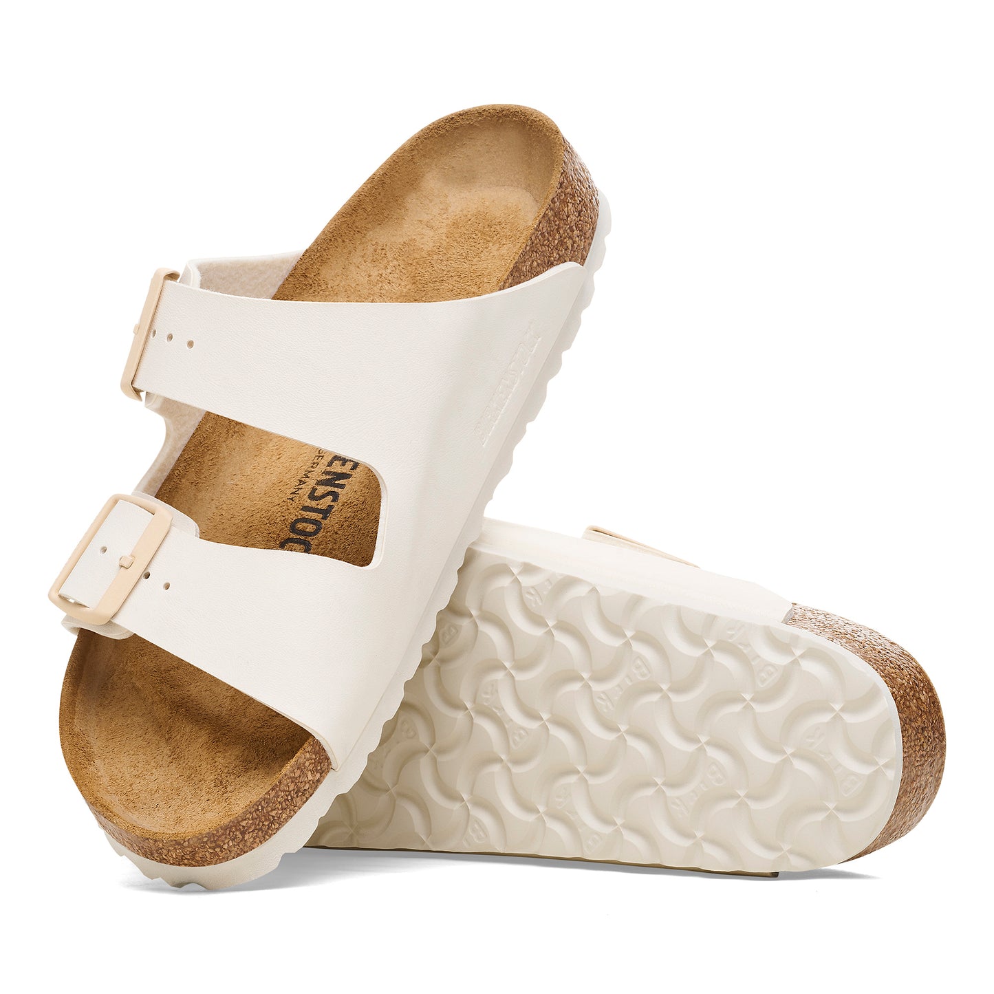 Two off-white sandals with two straps, buckle closures, and cork insoles.