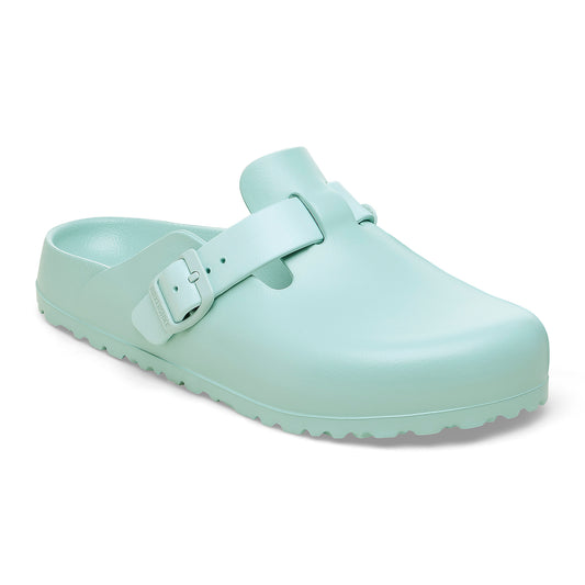 Side view of a mint green clog with adjustable strap.