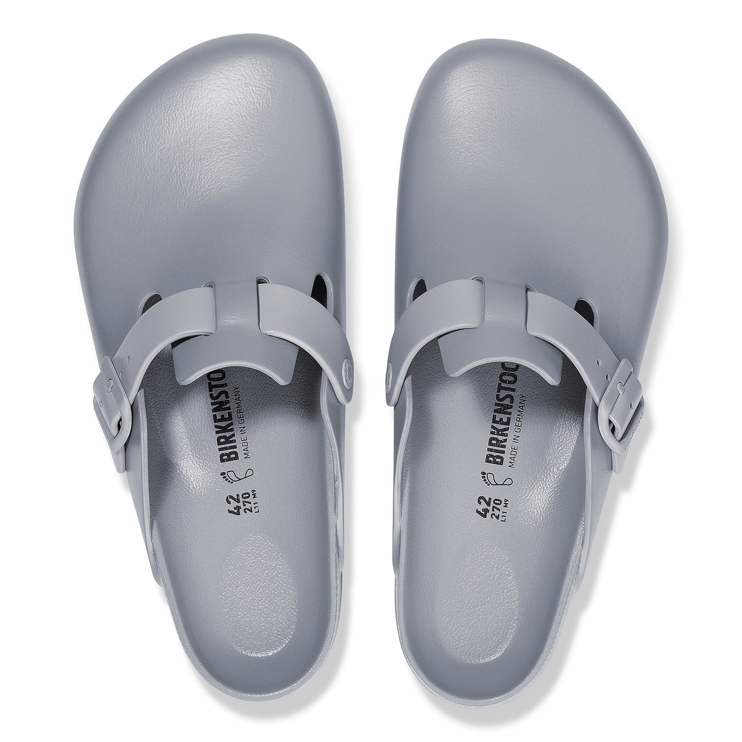 Two light gray clogs with adjustable buckle straps.