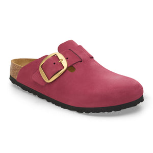 Slip-on shoe in dark red with a cork sole and a large gold buckle.
