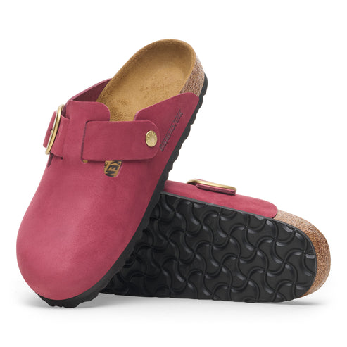 Pair of red suede clogs with adjustable buckle.