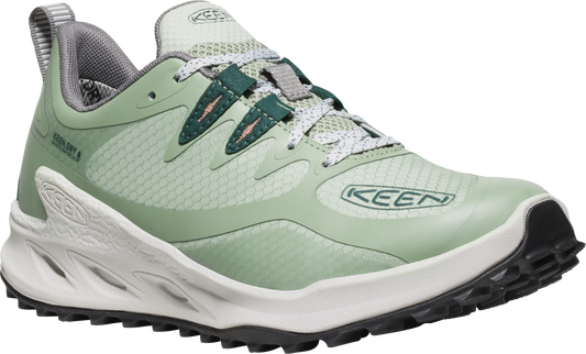 A sage-green shoe with dark-green accents and white soles, visible lacing and grey padded interior.