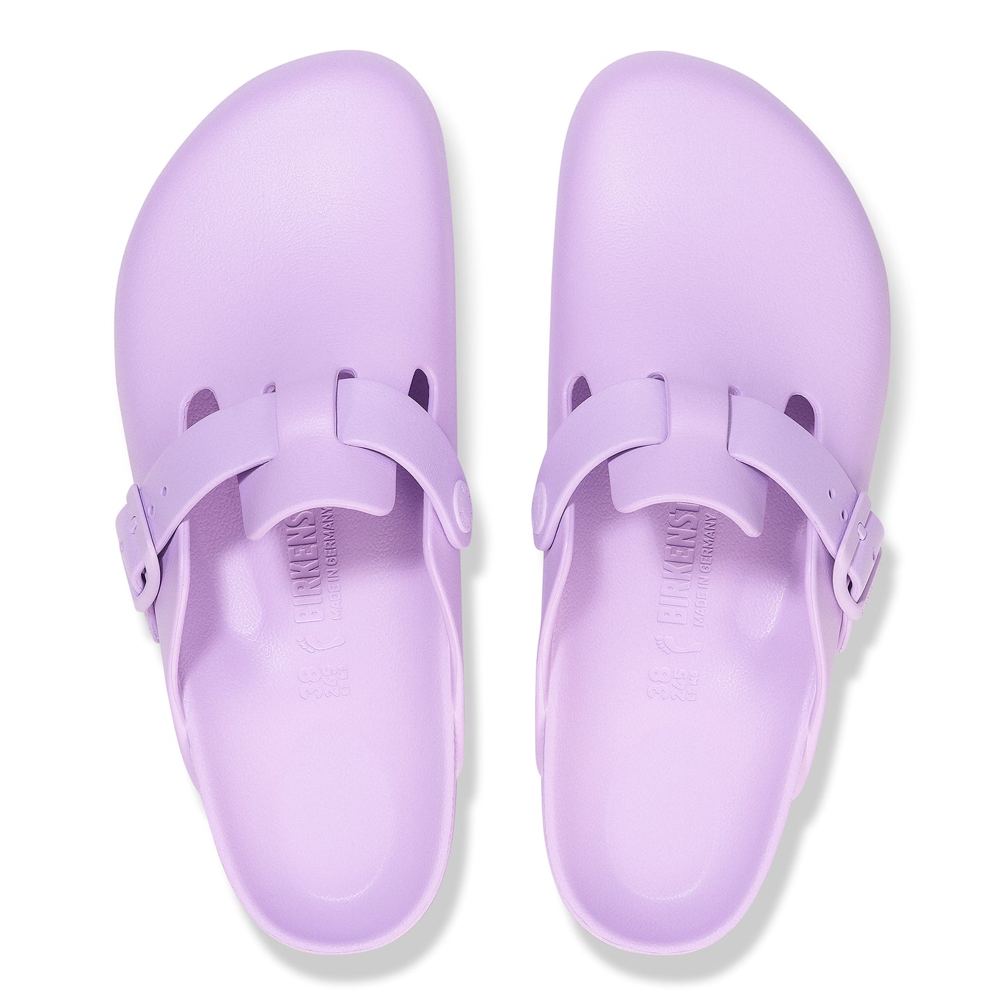 Pair of light purple clogs with adjustable straps and visible 'BIRKENSTOCK' imprint on the footbed.