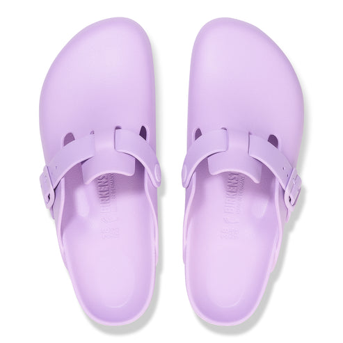 Pair of light purple clogs with adjustable straps and visible 'BIRKENSTOCK' imprint on the footbed.