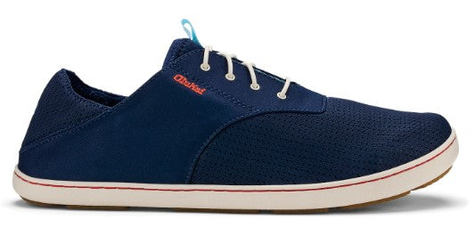 Navy blue boat shoe with white laces and the text OluKai on the side.