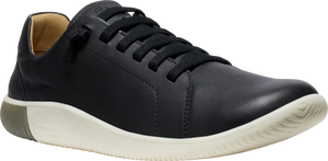 A black leather sneaker with black laces and a white sole.