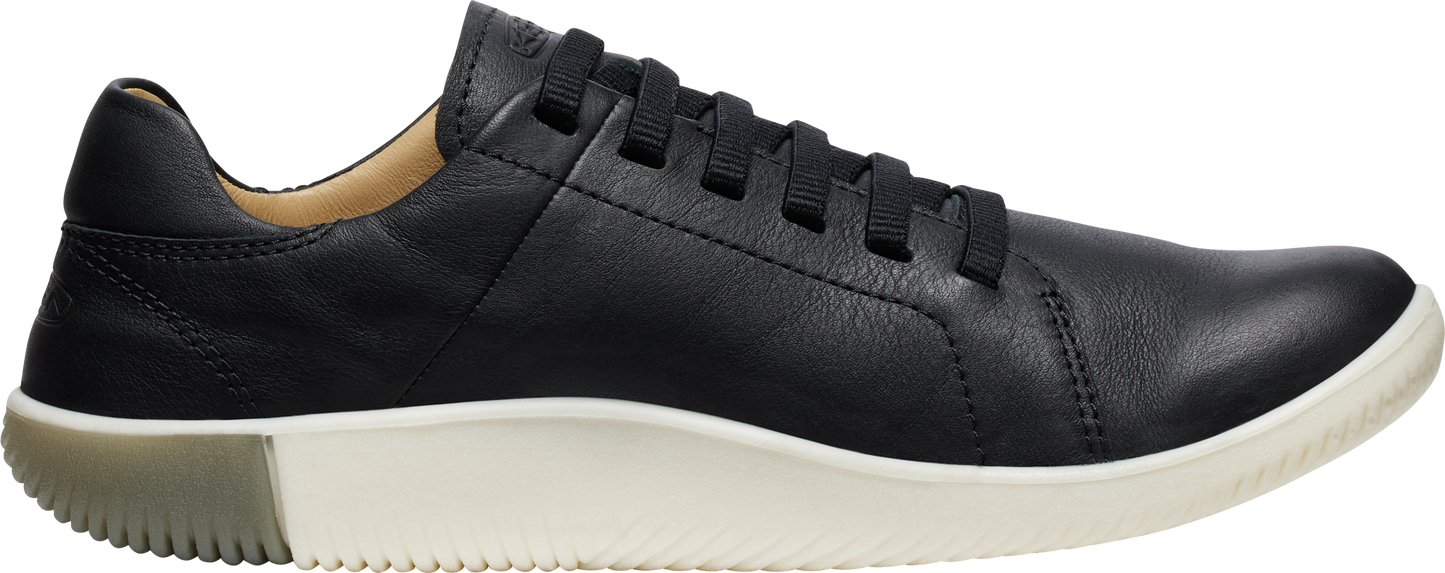 A black leather sneaker with white sole and black laces.