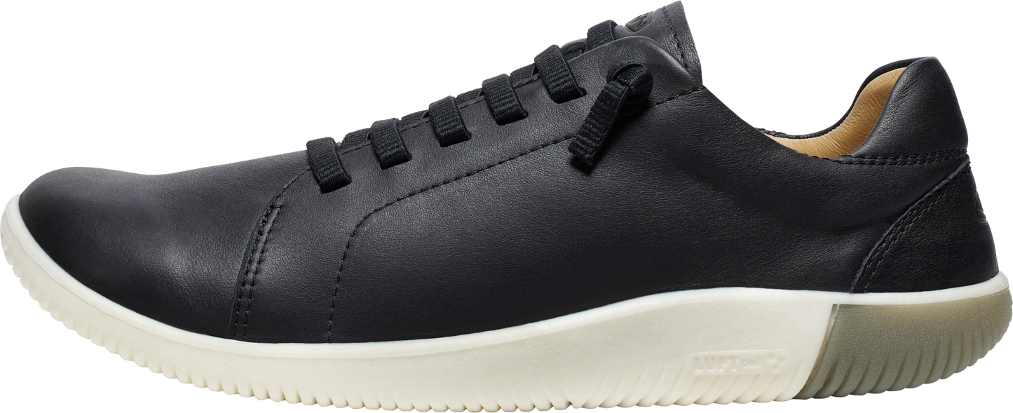 A black leather sneaker with a white sole and black laces.