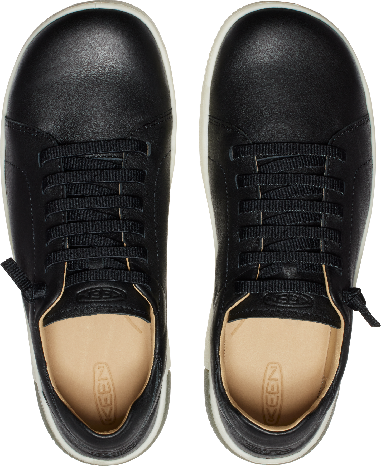 A pair of black leather sneakers, top view, with white soles and beige insoles.