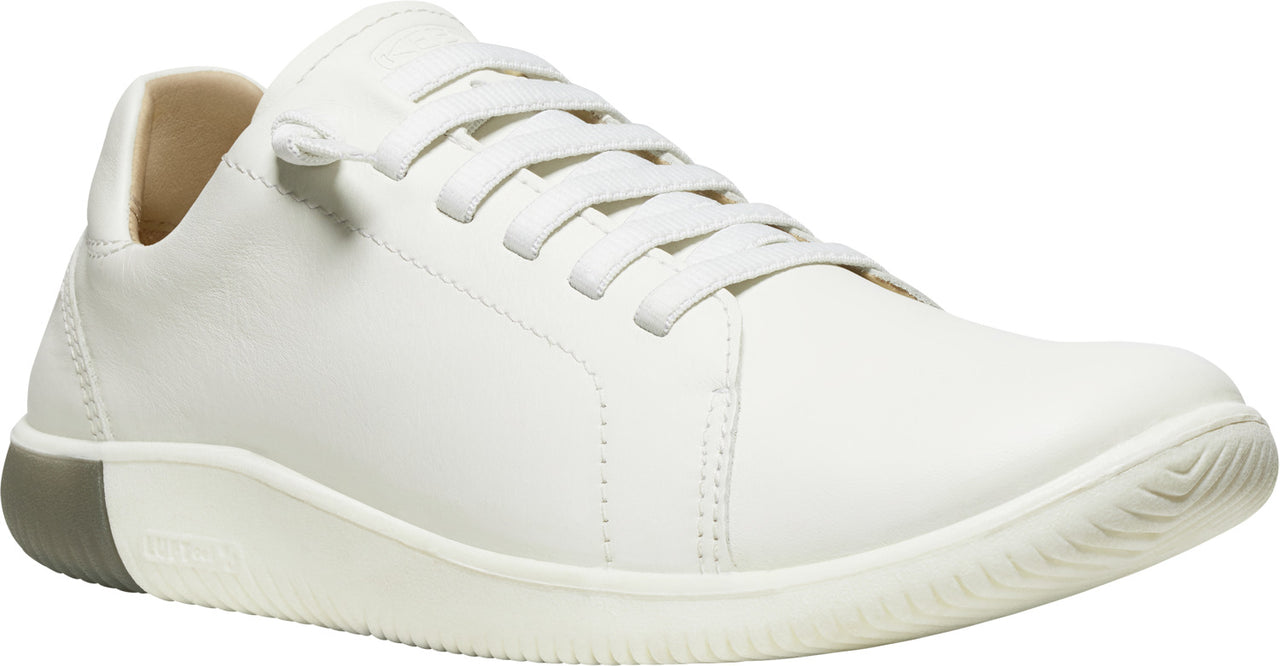 White leather sneaker with matching laces and a gray heel.