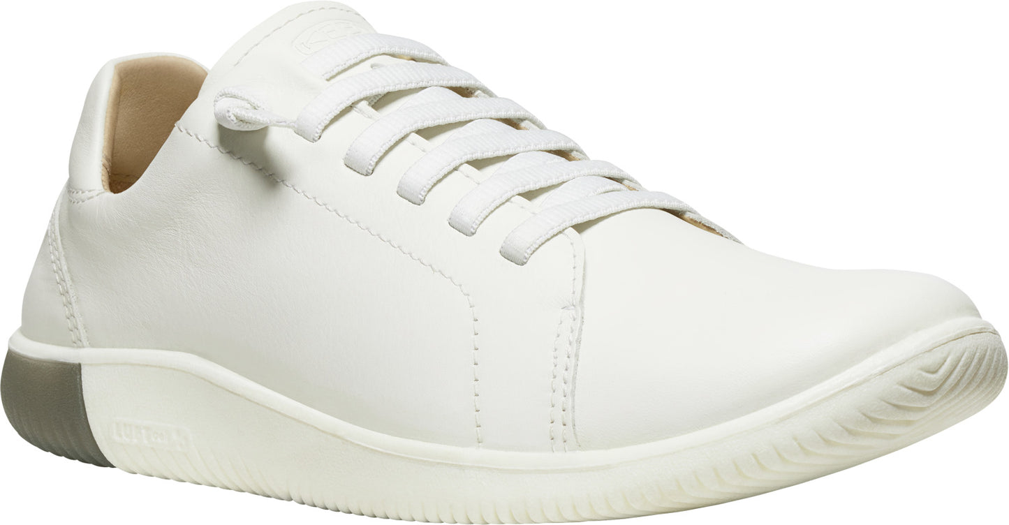 White leather sneaker with matching laces and a gray heel.
