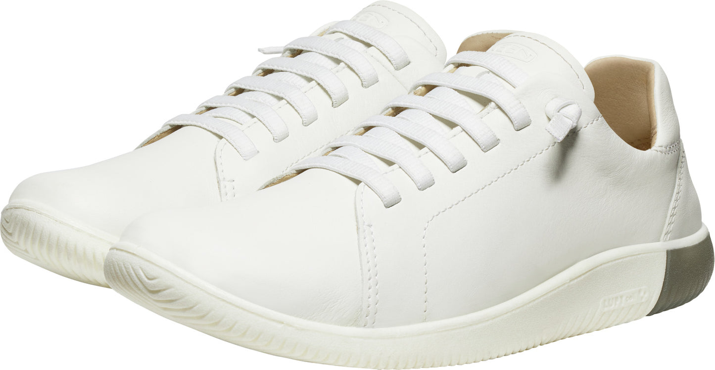 Pair of white, low-top sneakers with laces.
