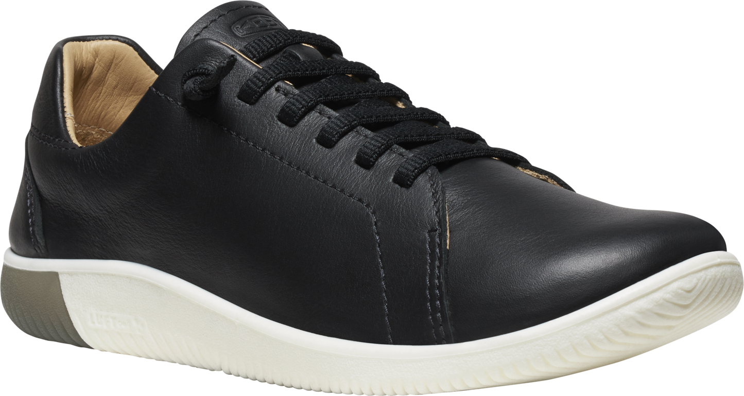 Black leather sneaker with white sole and lace-up closure.