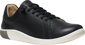 Black leather sneaker with white sole and lace-up closure.