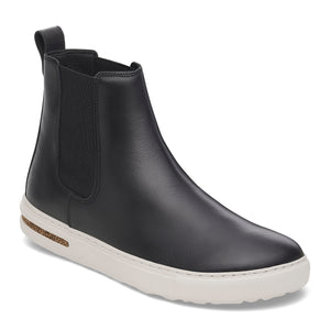 Black Chelsea boot with white rubber sole and a pull tab.