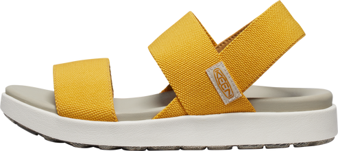 A yellow sandal with crossed straps.