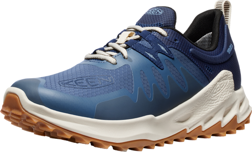 Low profile trail running shoe in blue with white laces and sole and brown lugs.