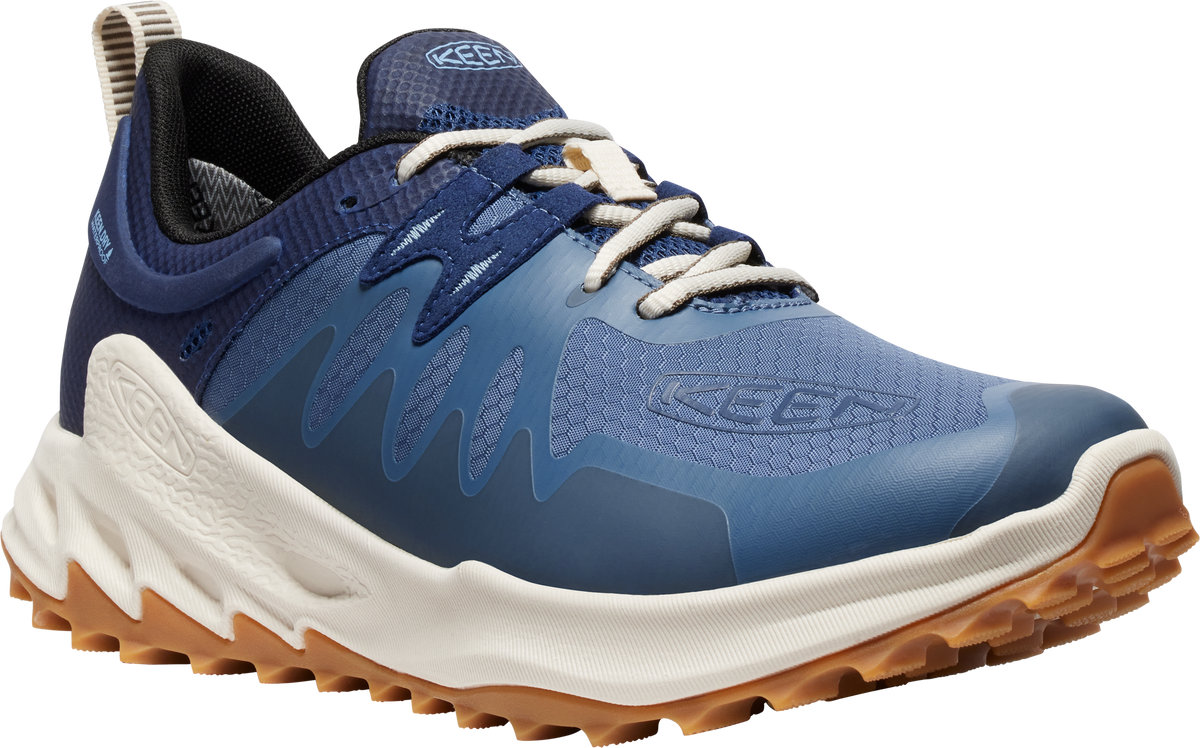 A blue running shoe with a white and brown sole and white laces.