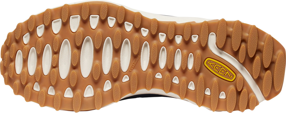 Bottom view of a shoe with brown and white rubber sole showing oval and rounded treads with brand name KEEN near the side.
