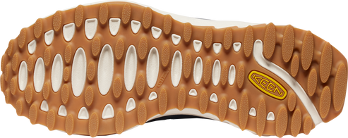 Bottom view of a shoe with brown and white rubber sole showing oval and rounded treads with brand name KEEN near the side.