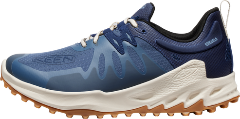 A blue and tan trail running shoe with white laces.