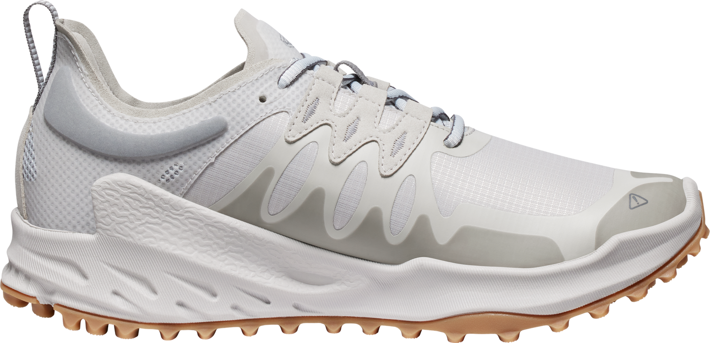 A white sneaker with a brown sole.